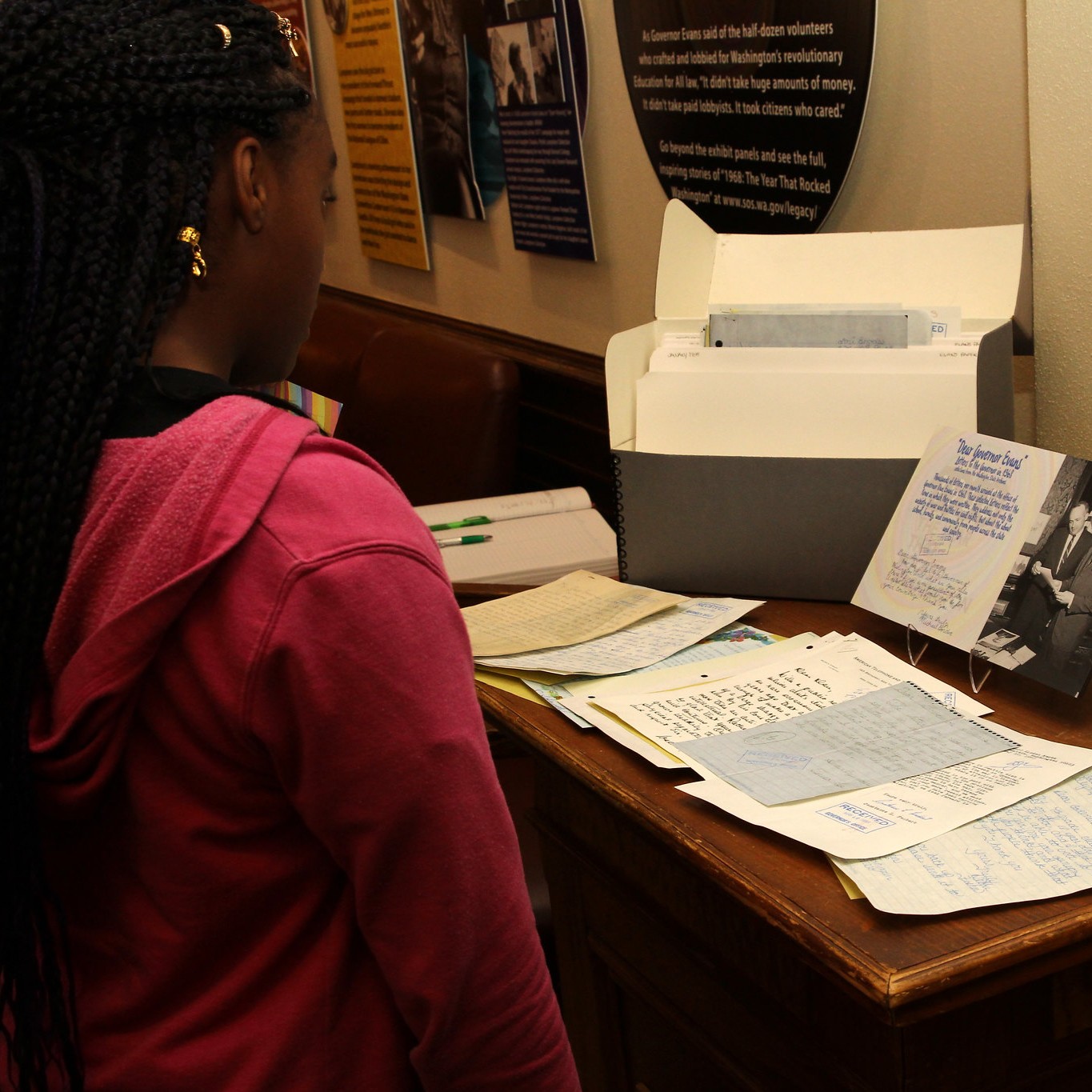 Young girl looks at historical writings