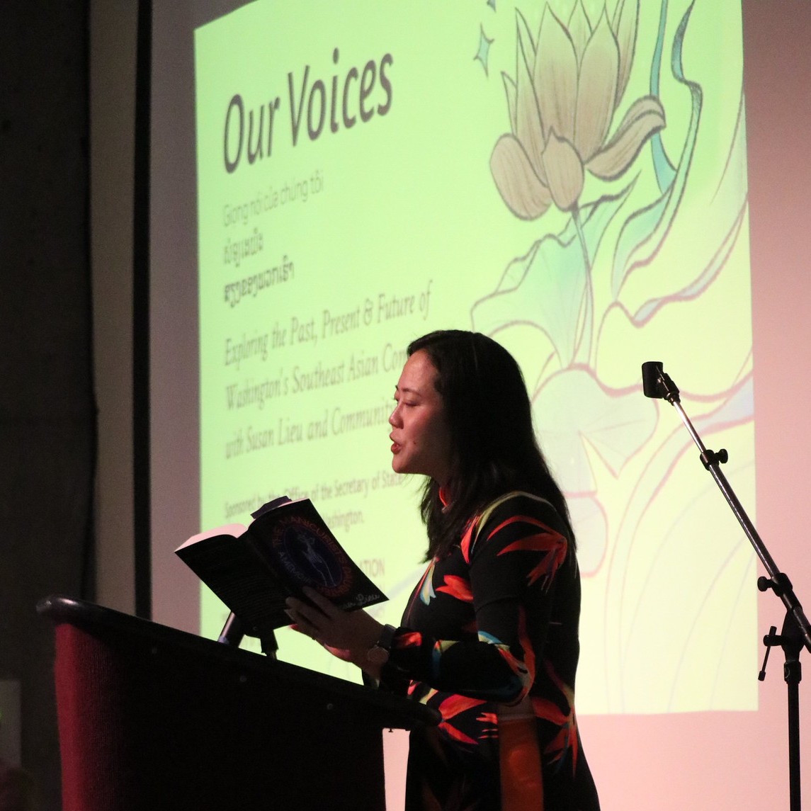 A speaker reading at the Legacy Washington "Our Voices" Event