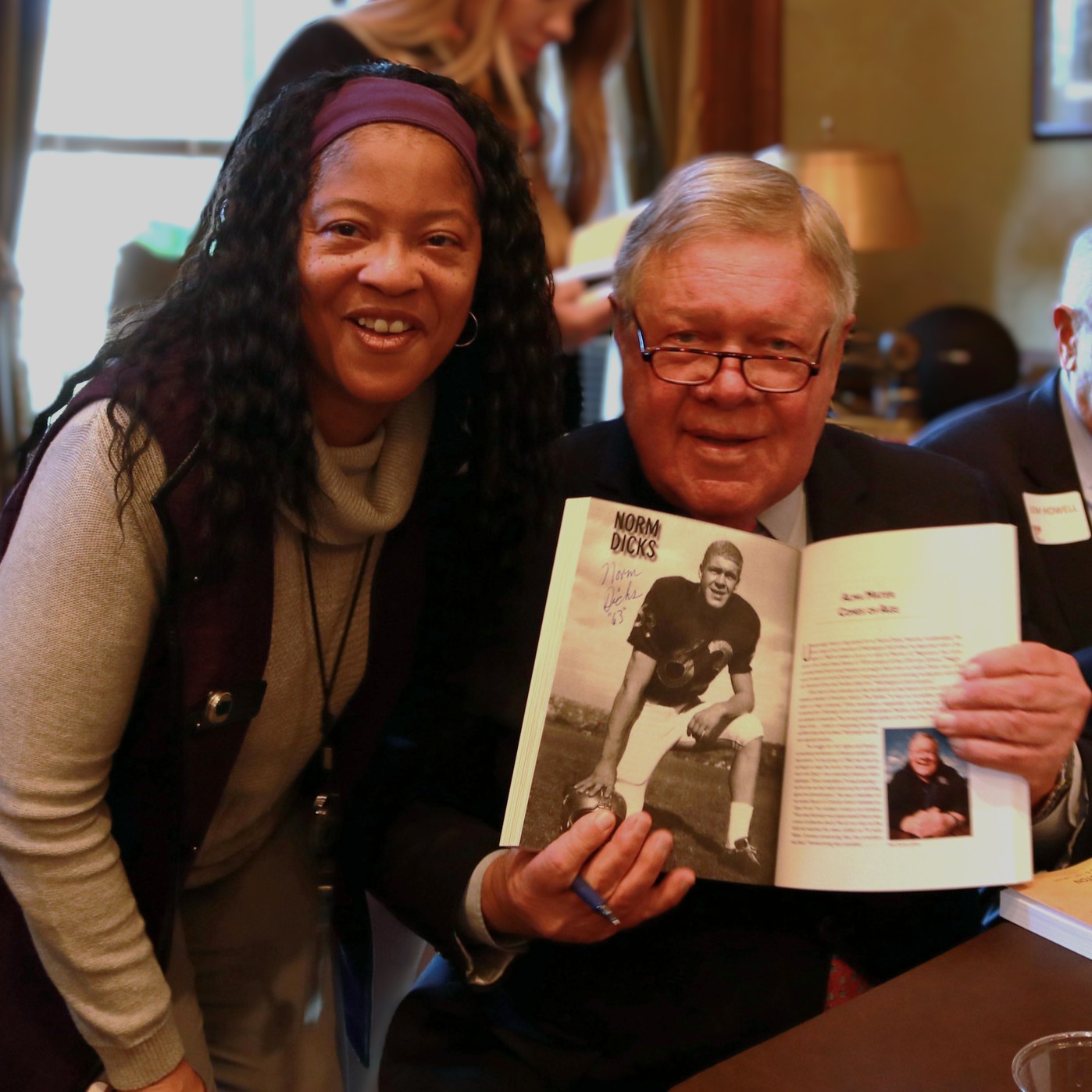 Legacy WA Books - man and woman, author holding book